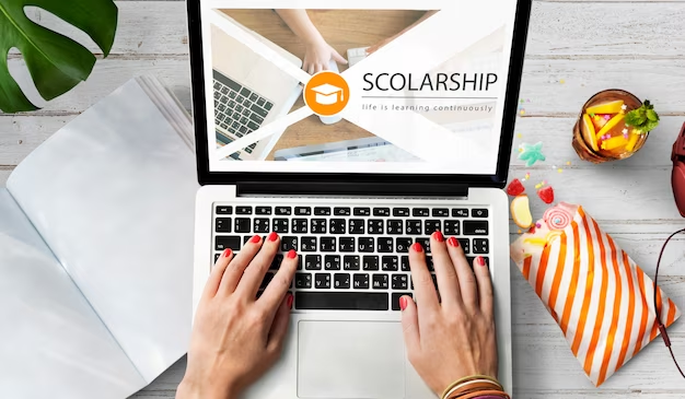 Hand using laptop with scholarship on the screen