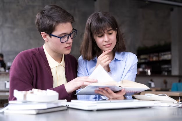 Two people reading a book