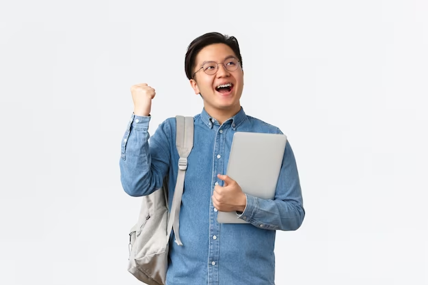 happy rejoicing asian male student