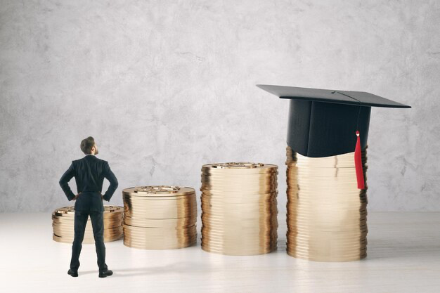 A man stands in front of coins and a graduate's headdress