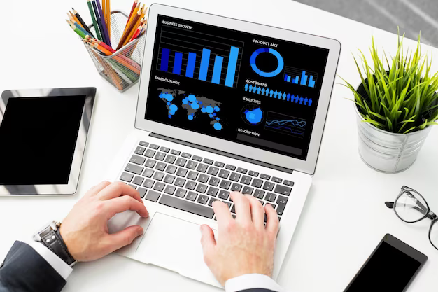 Man's hands on the keyboard of a laptop on the screen of which are graphics