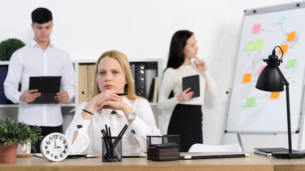 A group of people in white shirts work in the office