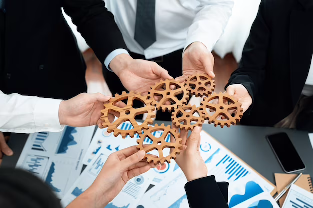 Hands, top view, holding gears over table